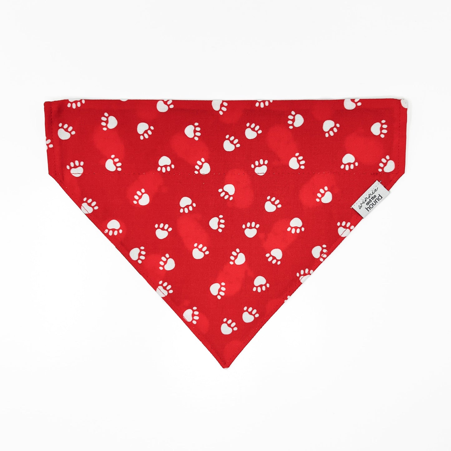 Red bandana with white paw prints on a white background