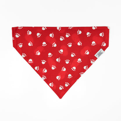 Red bandana with white paw prints on a white background
