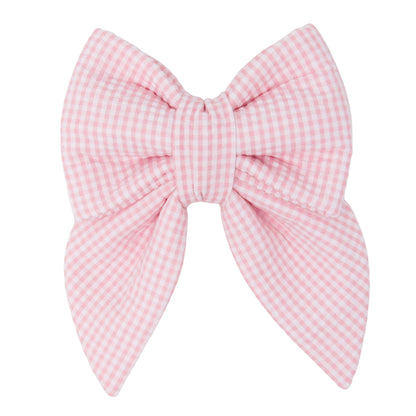 Pink seersucker gingham dog bow on a white background for Valentine's Day